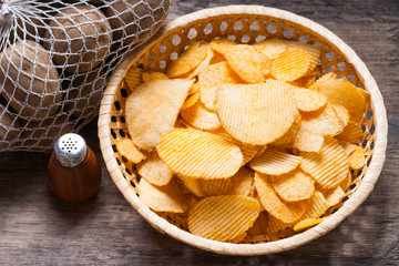 Crispy potato chips, spices and potato in a net