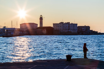 Colorful sunset in front of the city of Trieste