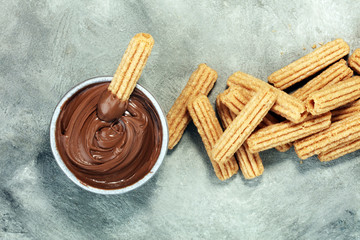Traditional Spanish dessert churros with sugar and chocolate