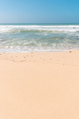Tropical beach background with soft wave, white sand and blue sky