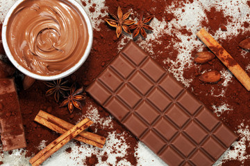 Chocolate bars on table with chocolate powder.