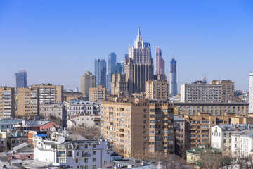Fototapeta premium view of Moscow cityscape, old historical town and urban skyscrapers (Moscow International Business Center background) with sunny blue sky, Moscow city, Russia