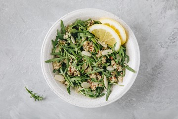 Quinoa salad with arugula and almonds. Vegetarian lunch bowl.