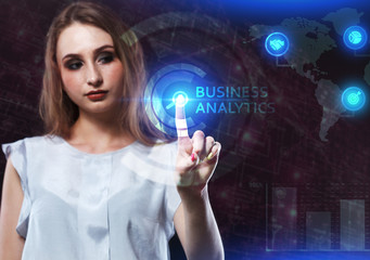 The concept of business, technology, the Internet and the network. A young entrepreneur working on a virtual screen of the future and sees the inscription: Business analytics