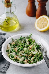 Quinoa salad with arugula and almonds. Vegetarian lunch bowl.