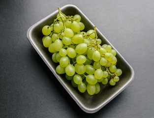 Green grapes on dark background. Selective focus with shallow depth of field.