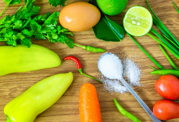 Sugar in a spoon of food clean eating selection placed on a wooden table.