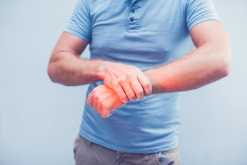 People, healthcare and problem concept - close up of man suffering from pain in hand over gray background