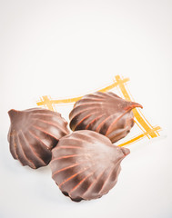 a few marshmallows in chocolate on a transparent dish on a light background