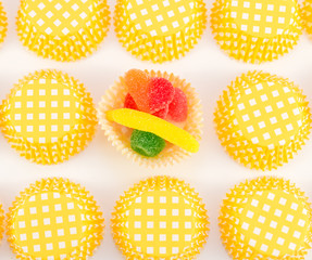 colorful candies in orange and white muffin molds