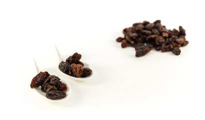 Dried raisins on a white background