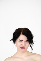 emotion face of aversion. reluctant displeased woman. young beautiful brunette girl portrait on white background.