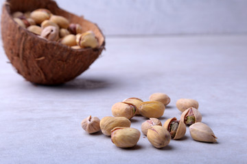 handmade bowl of coconut with pistachios isolated on a white background. Close-up.