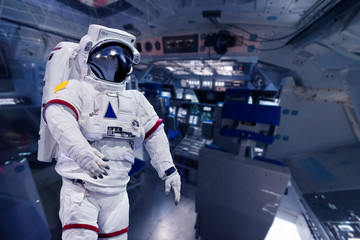 Astronaut pressure suit in a space shuttle cockpit ( NASA image not used ) © Siraphatphoto