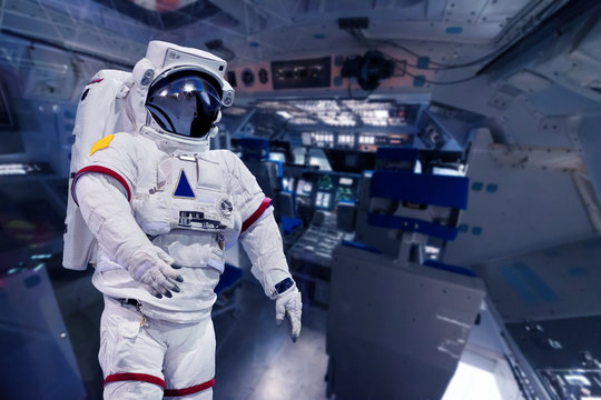 Astronaut pressure suit in a space shuttle cockpit ( NASA image not used )
