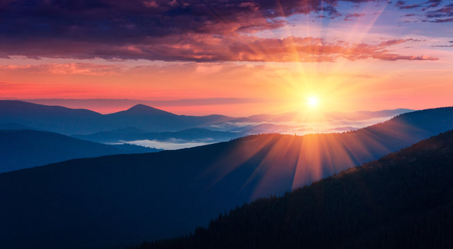 Fototapeta Panoramic view of colorful sunrise in mountains. Concept of the awakening wildlife, romance,emotional experience in your soul, joy in mundane life.