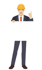 Businessman holding white blank poster and pointing up