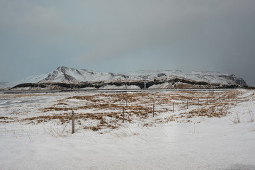 Dramatic icelandic landscape with snow covered mountains. Cold winter day in Iceland.