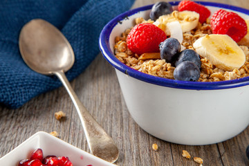 Granola and Berry Breakfast bowl with spoon
