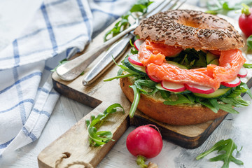 Fresh bagel with arugula, radish and smoked trout.
