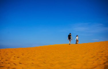Fototapeta na wymiar PHAN THIET, BINH THUAN, VIETNAM, May 7th, 2018: Red Sand Dunes and Sky near Mui Ne, Vietnam.