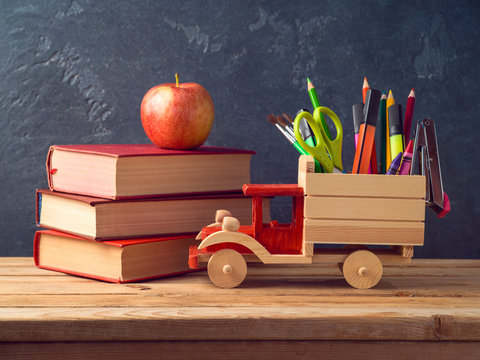Back to school concept with toy truck and school supplies