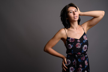 Young beautiful woman against gray background