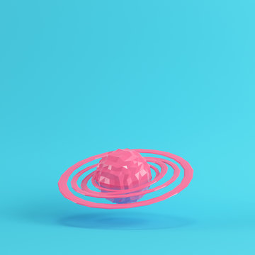 Pink abstract planet with rings on bright blue background in pastel colors