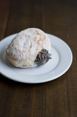 Choco Donut on a white plate and a wooden table 