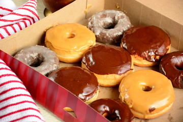 Fresh Donuts on a white wooden background with a coffee cup