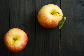 apples on black wooden table background