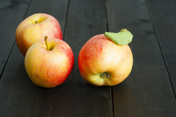 apples on black wooden table background