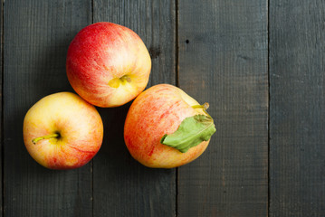 apples on black wooden table background