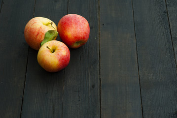 apples on black wooden table background