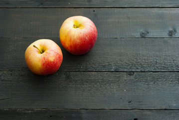 apples on black wooden table background