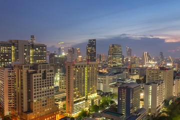 Obraz premium Night cityscape view of Bangkok modern office business building in business zone at Bangkok,Thailand. Bangkok is the capital of Thailand and also the most populated city in Thailand.