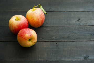 apples on black wooden table background