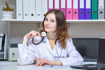 Portrait of a female doctor in office with an endoscope