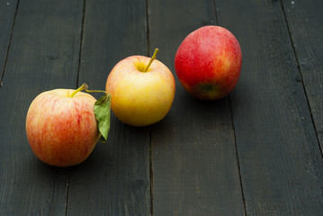 apples on black wooden table background