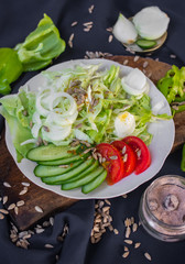 Fresh vegetables salad on plate. Slices of onion rings, tomatoes, cucumber, cabbage and capsicum. Healthy diet. Raw vegan vegetarian food