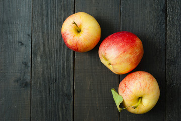 apples on black wooden table background
