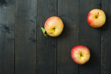 apples on black wooden table background