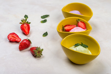 Colorful fruit  ice cream balls in bowls on white background
