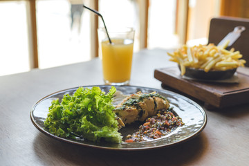 Lunch in restaurant. Meat with salad and glass of juice.
