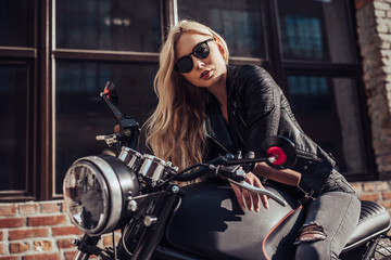 Fototapeta na wymiar Woman with black motorcycle