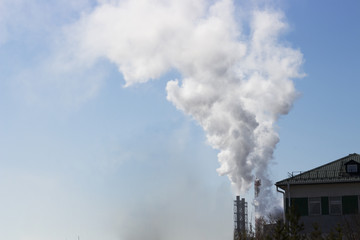 Thick white smok from factory pipes, pollution concept © TATIANA KIM