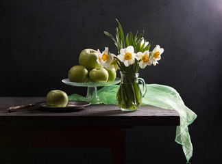 Still life with daffodils and apples