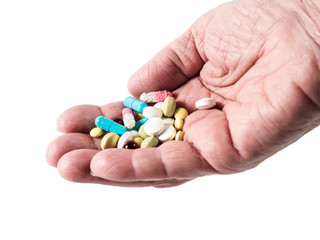 Pills and capsules on palm isolated on white background