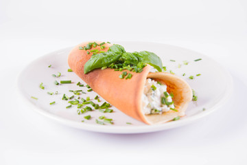Pancake with cottage cheese and chives decorated with basil