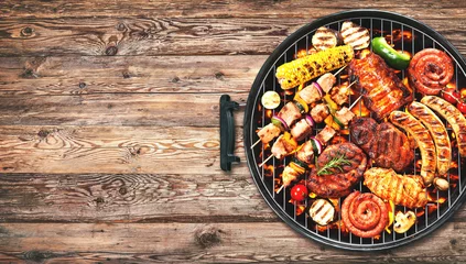 Wall murals Grill / Barbecue Assorted delicious grilled meat and bratwurst with vegetables on grill